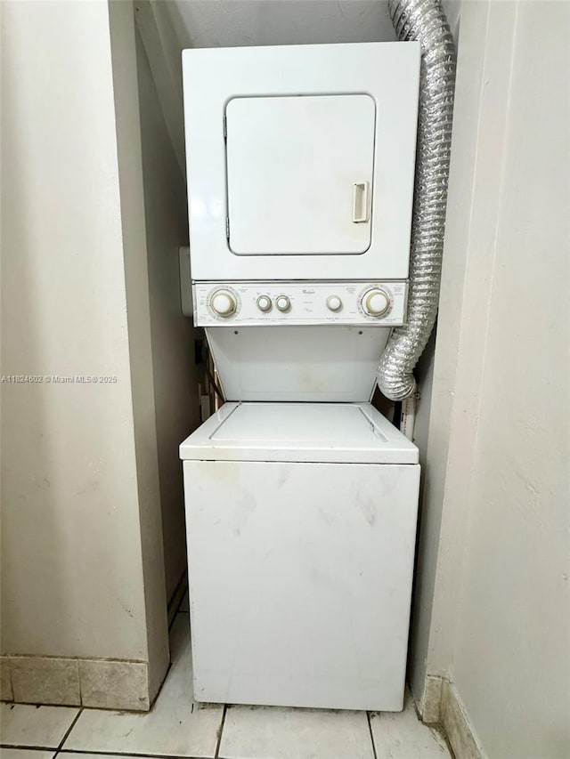 2562 NW 52nd Ave Unit B18, Lauderhill, FL 33313 - laundry room featuring stacked washer / dryer and light tile patterned floors