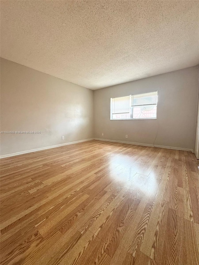 2562 NW 52nd Ave Unit B18, Lauderhill, FL 33313 - unfurnished room with a textured ceiling and light wood-style floors