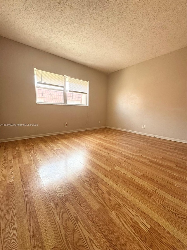 2562 NW 52nd Ave Unit B18, Lauderhill, FL 33313 - empty room featuring light wood-type flooring and a textured ceiling