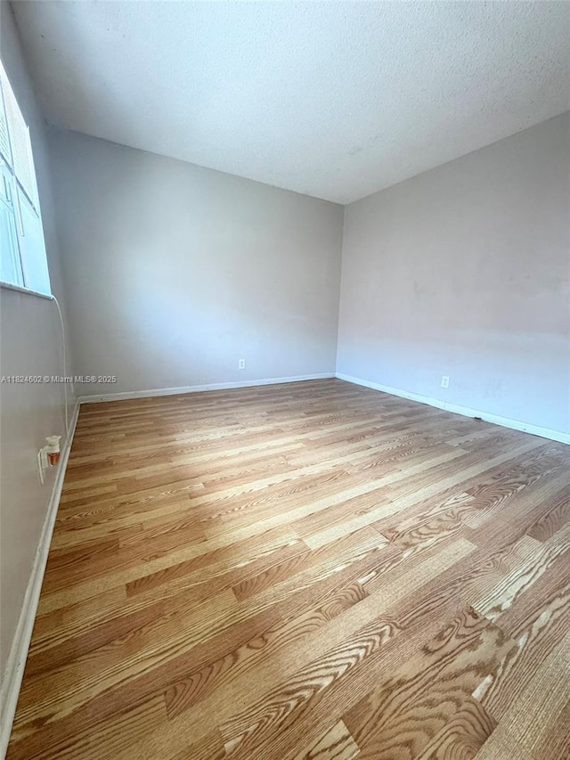 2562 NW 52nd Ave Unit B18, Lauderhill, FL 33313 - spare room featuring light wood-style floors and a textured ceiling