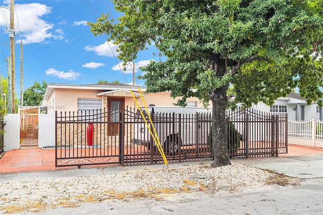 31 SW 58th Ct, Miami, FL 33144 - obstructed view of property with stucco siding and a fenced front yard