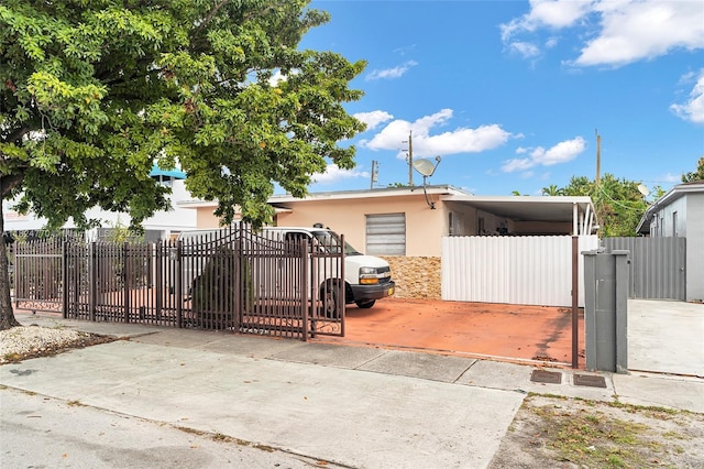 31 SW 58th Ct, Miami, FL 33144 - view of front of home with a fenced front yard, a gate, and stucco siding