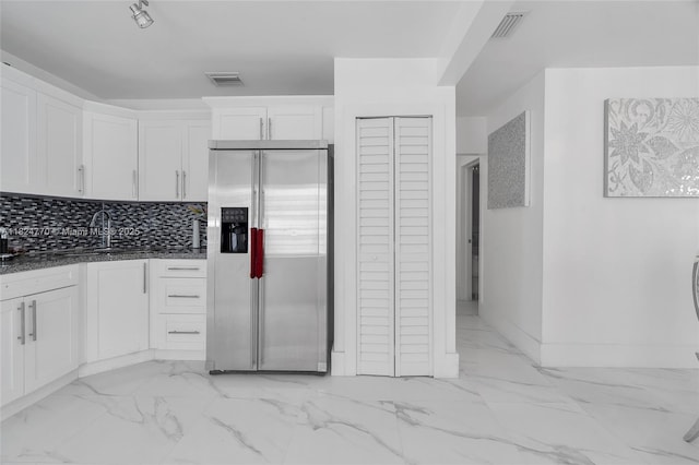 31 SW 58th Ct, Miami, FL 33144 - kitchen with stainless steel fridge, white cabinetry, light marble finish flooring, and dark stone counters