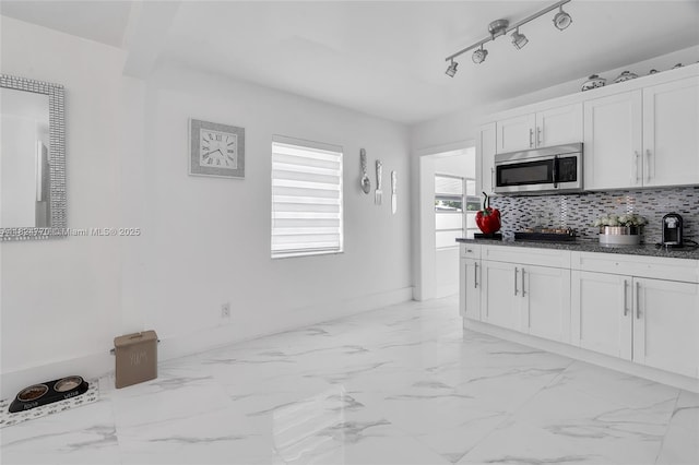 31 SW 58th Ct, Miami, FL 33144 - kitchen with stainless steel microwave, tasteful backsplash, white cabinets, and light marble finish flooring