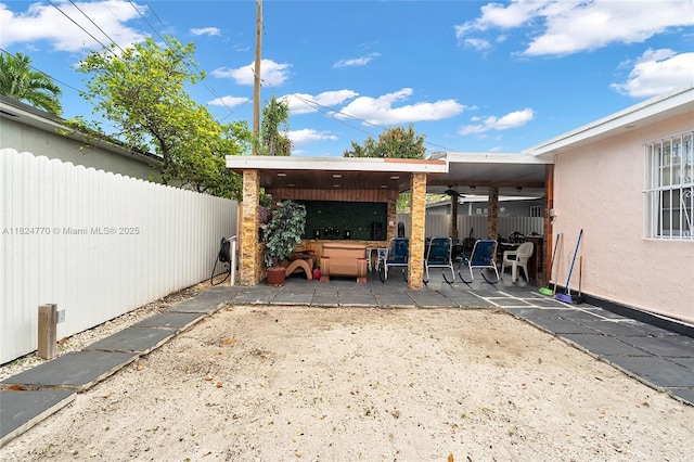 31 SW 58th Ct, Miami, FL 33144 - fenced backyard with a ceiling fan and a patio