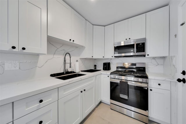 6900 N Kendall Dr Unit A303, Pinecrest, FL 33156 - kitchen with appliances with stainless steel finishes, white cabinets, decorative backsplash, light stone countertops, and light tile patterned flooring