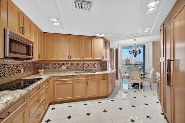 2800 Island Blvd Unit 1505, Aventura, FL 33160 - kitchen with stainless steel microwave, a chandelier, black electric cooktop, tasteful backsplash, and light stone counters