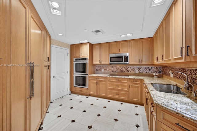 2800 Island Blvd Unit 1505, Aventura, FL 33160 - kitchen with appliances with stainless steel finishes, light stone counters, and decorative backsplash