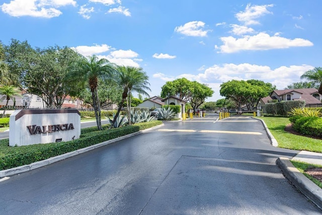 10091 SW 137th Pl, Miami, FL 33186 - view of asphalt road featuring curbs, a gated entry, and a residential view