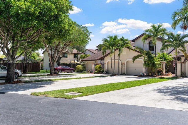 10091 SW 137th Pl, Miami, FL 33186 - view of front of home featuring concrete driveway, a garage, and stucco siding