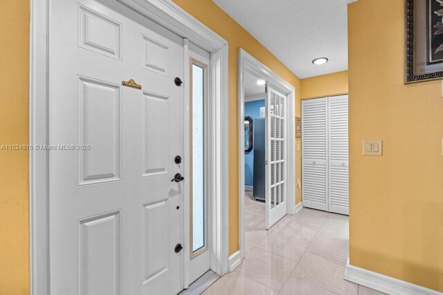 10091 SW 137th Pl, Miami, FL 33186 - foyer with baseboards and light tile patterned floors