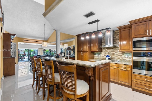 10091 SW 137th Pl, Miami, FL 33186 - kitchen with stainless steel appliances, wall chimney range hood, tasteful backsplash, open floor plan, and light stone counters