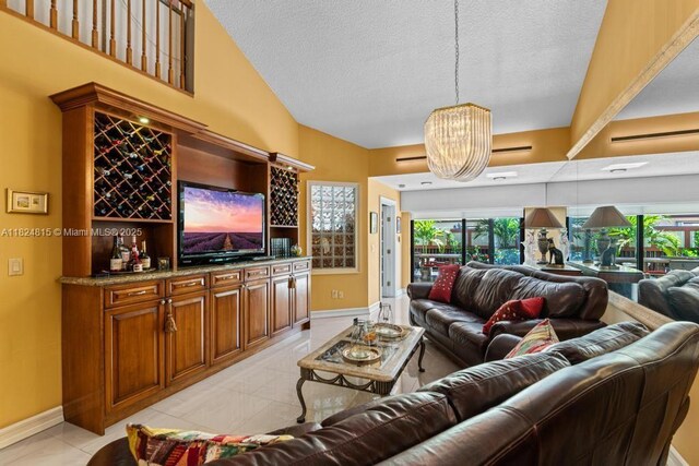 10091 SW 137th Pl, Miami, FL 33186 - living room featuring a textured ceiling, a chandelier, and plenty of natural light