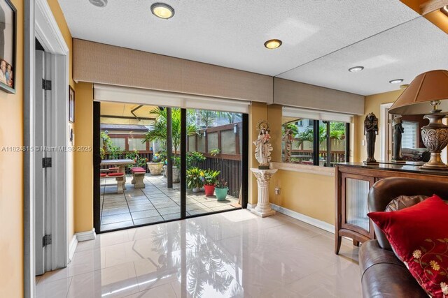 10091 SW 137th Pl, Miami, FL 33186 - doorway to outside with plenty of natural light, a textured ceiling, and recessed lighting