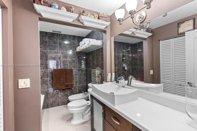 10091 SW 137th Pl, Miami, FL 33186 - full bath featuring a bidet, vanity, tile patterned flooring, a closet, and tile walls