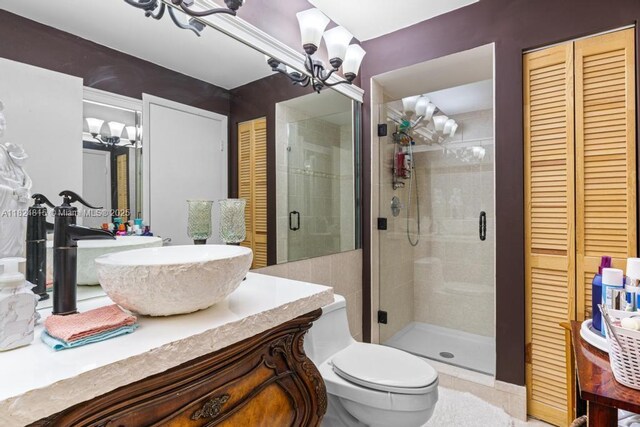 10091 SW 137th Pl, Miami, FL 33186 - bathroom with a chandelier, a closet, a shower stall, and vanity