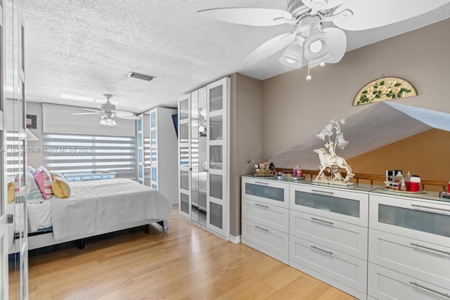 10091 SW 137th Pl, Miami, FL 33186 - bedroom featuring a textured ceiling, light wood-style flooring, and ceiling fan