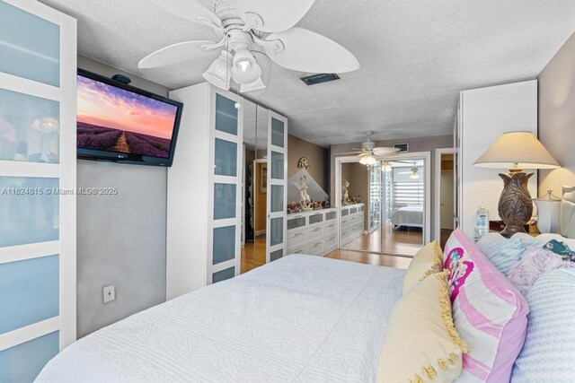 10091 SW 137th Pl, Miami, FL 33186 - bedroom featuring a textured ceiling, wood finished floors, and ceiling fan