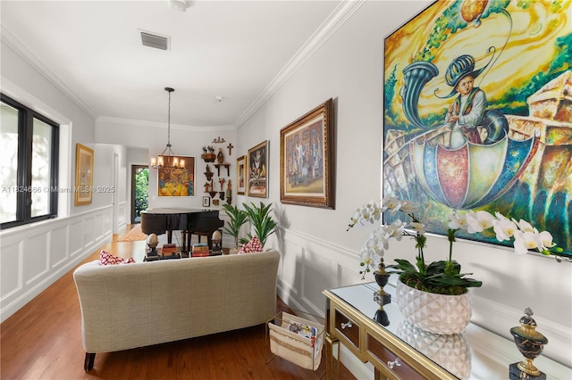 1460 Mantua Ave, Coral Gables, FL 33146 - living room with ornamental molding, a decorative wall, a chandelier, dark wood-type flooring, and a wainscoted wall