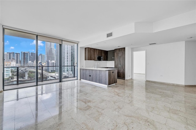 68 SE 6th St Unit 712, Miami, FL 33131 - unfurnished living room with a skyline view, expansive windows, and light marble finish floors