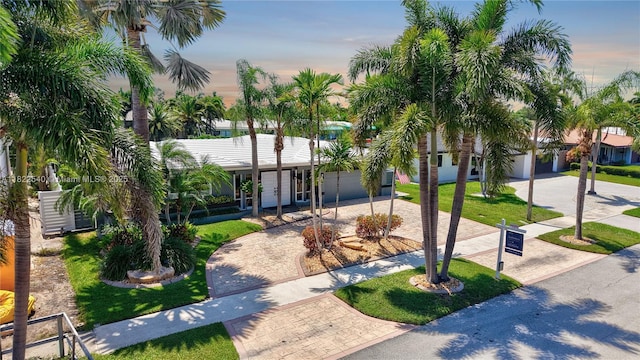 501 SE 7th Ave, Pompano Beach, FL 33060 - view of front of home with decorative driveway, a front yard, and an attached garage
