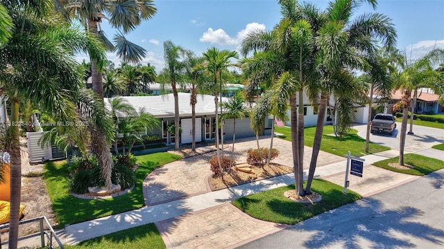 501 SE 7th Ave, Pompano Beach, FL 33060 - view of front of house with decorative driveway, an attached garage, and a front yard