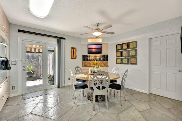 501 SE 7th Ave, Pompano Beach, FL 33060 - dining space featuring stone tile floors, ceiling fan, and a textured ceiling