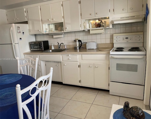 223 S Federal Hwy Unit 46, Dania Beach, FL 33004 - kitchen with white appliances, under cabinet range hood, light countertops, and backsplash