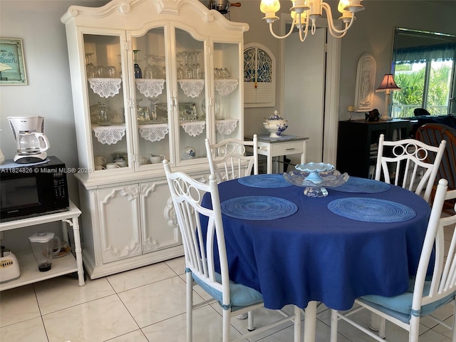 223 S Federal Hwy Unit 46, Dania Beach, FL 33004 - dining area with a chandelier and light tile patterned floors