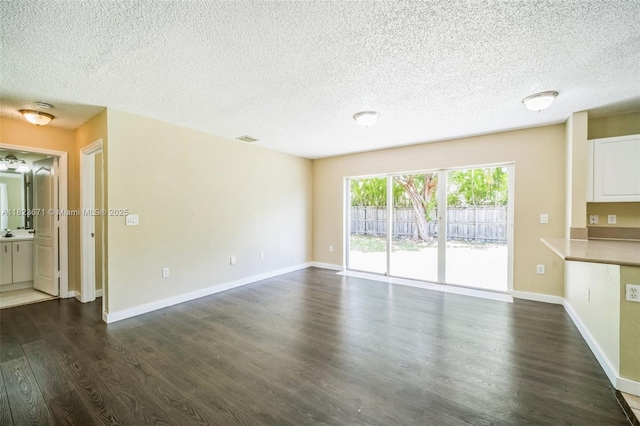 8995 SW 213th St, Cutler Bay, FL 33189 - unfurnished living room with dark wood finished floors and a textured ceiling