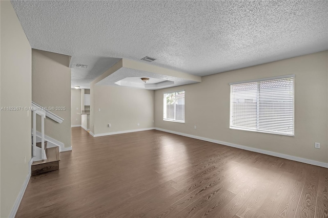 8995 SW 213th St, Cutler Bay, FL 33189 - unfurnished living room featuring a textured ceiling, dark wood-style flooring, and stairs