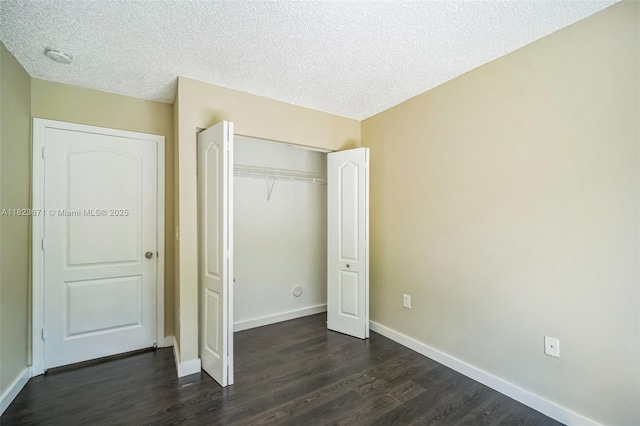 8995 SW 213th St, Cutler Bay, FL 33189 - unfurnished bedroom featuring dark wood-style flooring, a closet, and a textured ceiling