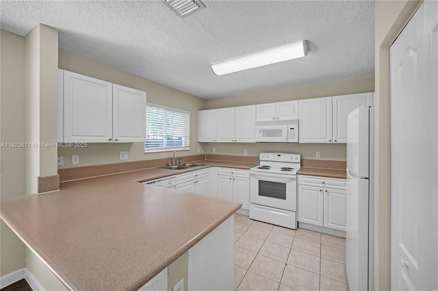 8995 SW 213th St, Cutler Bay, FL 33189 - kitchen featuring white appliances, a peninsula, white cabinets, a textured ceiling, and light tile patterned floors