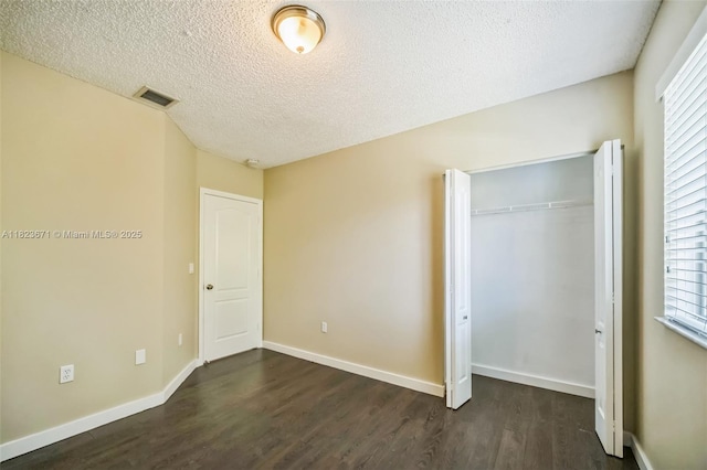 8995 SW 213th St, Cutler Bay, FL 33189 - unfurnished bedroom with dark wood finished floors, a closet, and a textured ceiling