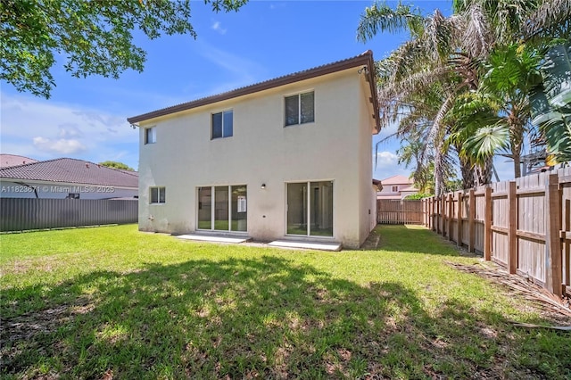 8995 SW 213th St, Cutler Bay, FL 33189 - rear view of house featuring stucco siding and a fenced backyard