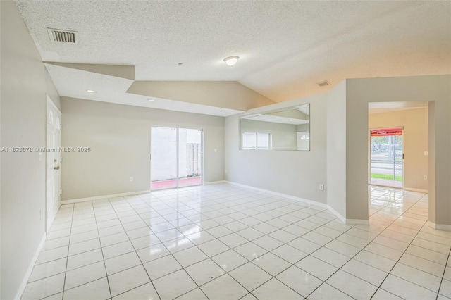 9537 SW 154th Ave, Miami, FL 33196 - empty room featuring light tile patterned floors, lofted ceiling, and a textured ceiling