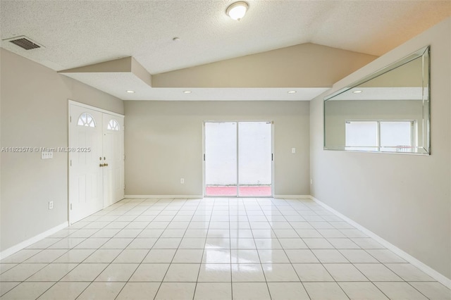 9537 SW 154th Ave, Miami, FL 33196 - spare room with a textured ceiling, light tile patterned floors, vaulted ceiling, and recessed lighting