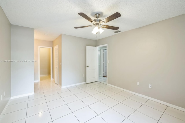 9537 SW 154th Ave, Miami, FL 33196 - unfurnished bedroom with a ceiling fan, light tile patterned floors, and a textured ceiling
