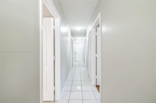 9537 SW 154th Ave, Miami, FL 33196 - hall featuring a textured ceiling and light tile patterned flooring