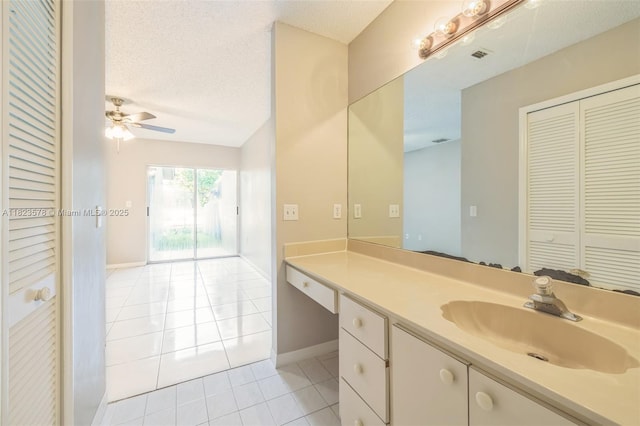 9537 SW 154th Ave, Miami, FL 33196 - bathroom with tile patterned floors, vanity, a closet, a ceiling fan, and a textured ceiling
