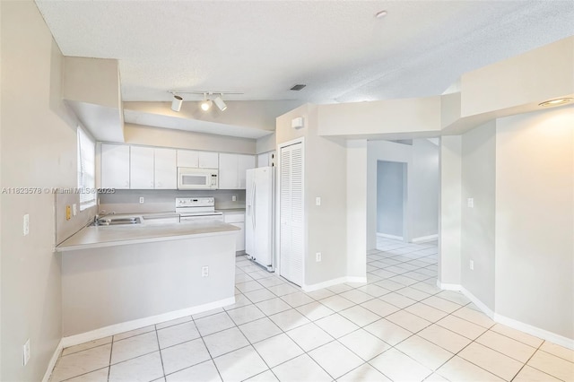 9537 SW 154th Ave, Miami, FL 33196 - kitchen featuring white appliances, light countertops, light tile patterned floors, white cabinetry, and a peninsula