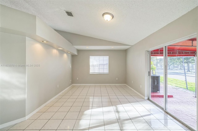 9537 SW 154th Ave, Miami, FL 33196 - empty room featuring vaulted ceiling, light tile patterned floors, and a textured ceiling