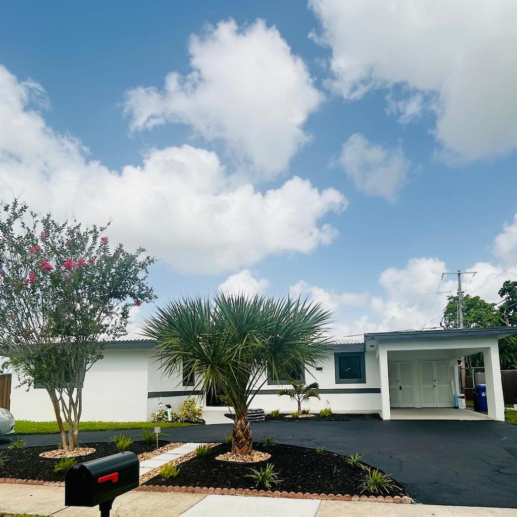 1157 SW 4th Ave, Pompano Beach, FL 33060 - view of front of home featuring a carport, asphalt driveway, and stucco siding
