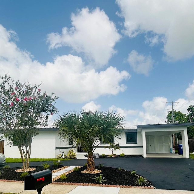 1157 SW 4th Ave, Pompano Beach, FL 33060 - view of front of home featuring a carport, asphalt driveway, and stucco siding