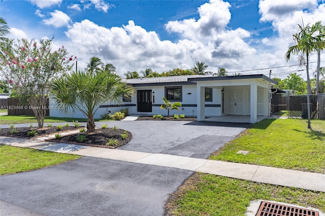 1157 SW 4th Ave, Pompano Beach, FL 33060 - view of front facade with driveway, stucco siding, and a carport