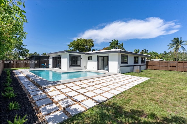 1157 SW 4th Ave, Pompano Beach, FL 33060 - back of property with a fenced backyard, a patio, stucco siding, and a sunroom
