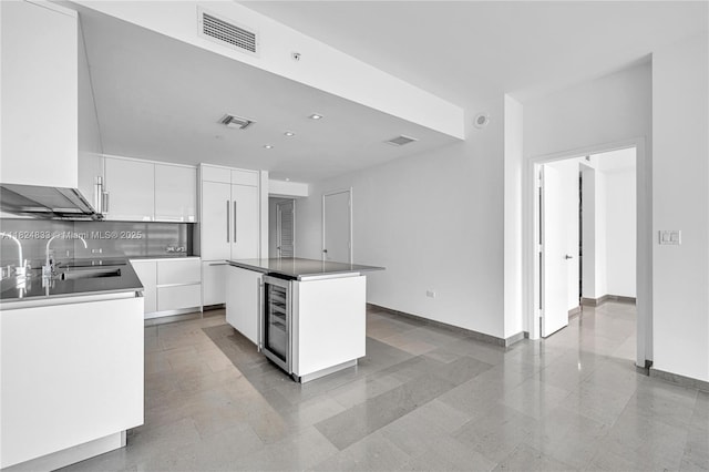 88 SW 7th St Unit 1006, Miami, FL 33130 - kitchen featuring modern cabinets, white cabinets, a center island, beverage cooler, and recessed lighting