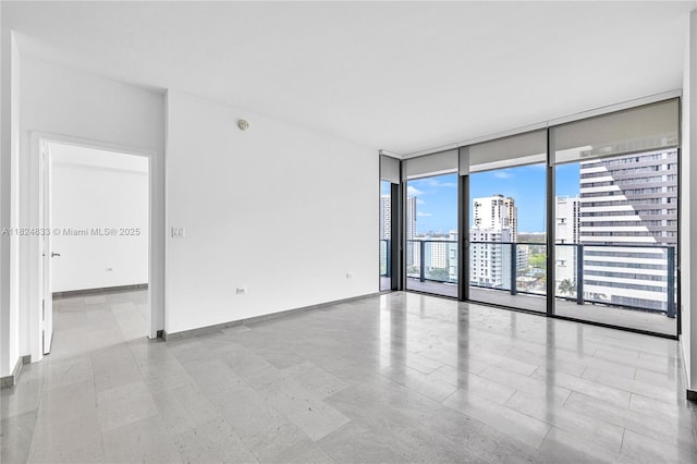 88 SW 7th St Unit 1006, Miami, FL 33130 - spare room with a wall of windows and a city view