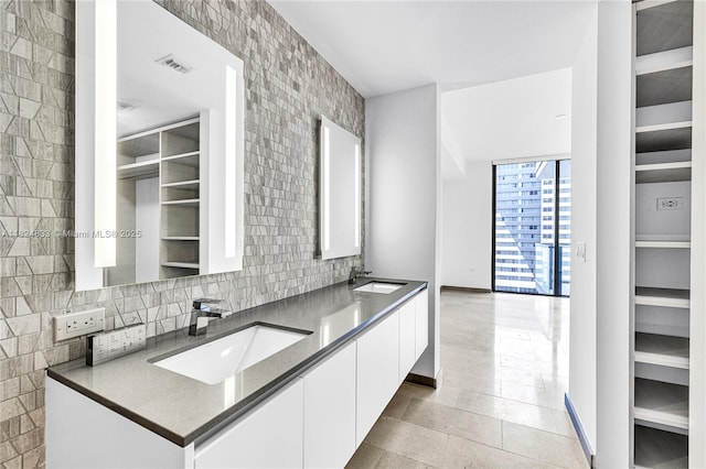 88 SW 7th St Unit 1006, Miami, FL 33130 - bathroom with double vanity, tile patterned flooring, and tasteful backsplash
