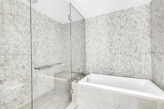88 SW 7th St Unit 1006, Miami, FL 33130 - full bath featuring tile walls, a stall shower, and a bath